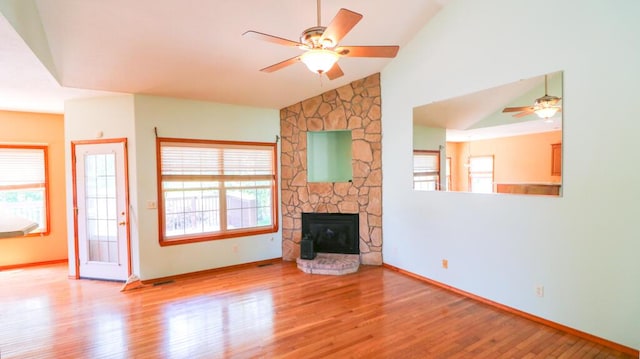 5546 S Aspen Dr, Battlefield, MO 65619 - unfurnished living room featuring ceiling fan, wood finished floors, a stone fireplace, and high vaulted ceiling