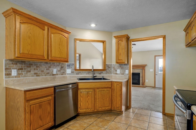 844 S Natalie Ave, Springfield, MO 65802 - kitchen with stainless steel appliances, light countertops, tasteful backsplash, light tile patterned flooring, and a tile fireplace