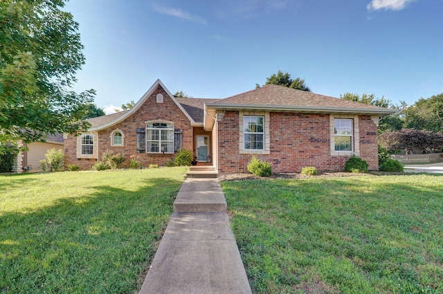 5055 E Cherry Pl, Springfield, MO 65809 - view of front of house with brick siding, a front lawn, and a shingled roof