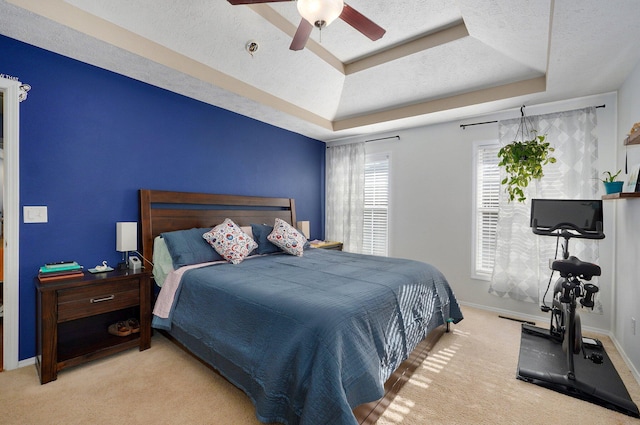 5055 E Cherry Pl, Springfield, MO 65809 - carpeted bedroom with a tray ceiling, ceiling fan, and a textured ceiling