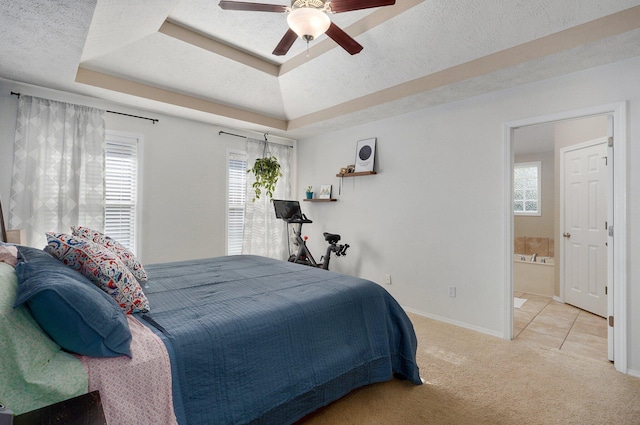 5055 E Cherry Pl, Springfield, MO 65809 - bedroom featuring a tray ceiling, multiple windows, carpet floors, and a ceiling fan