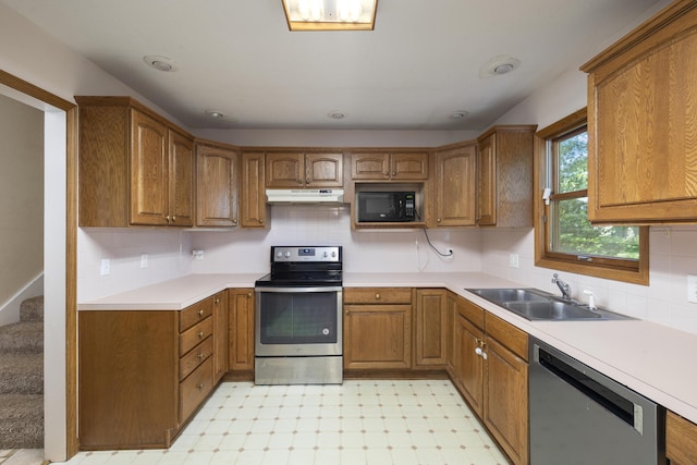 2266 E Barataria St, Springfield, MO 65804 - kitchen featuring appliances with stainless steel finishes, brown cabinets, light floors, and under cabinet range hood
