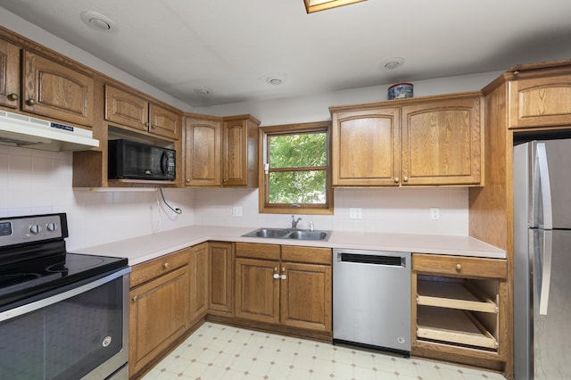 2266 E Barataria St, Springfield, MO 65804 - kitchen featuring stainless steel appliances, under cabinet range hood, light floors, brown cabinets, and light countertops