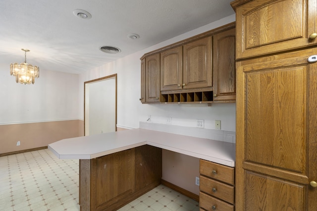 2266 E Barataria St, Springfield, MO 65804 - kitchen featuring light floors, a peninsula, light countertops, a chandelier, and hanging light fixtures