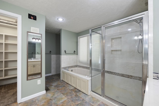 2266 E Barataria St, Springfield, MO 65804 - full bathroom with a shower stall, a garden tub, vanity, and a textured ceiling