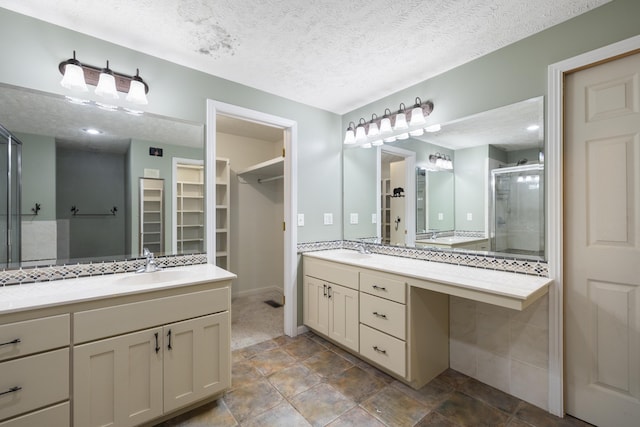 2266 E Barataria St, Springfield, MO 65804 - full bath featuring a shower stall, a spacious closet, two vanities, and a textured ceiling