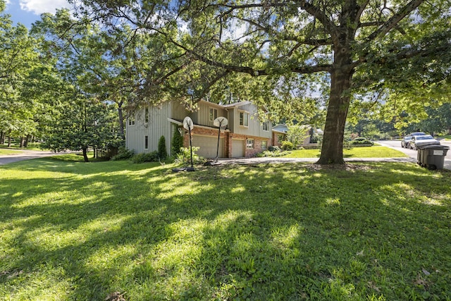 2266 E Barataria St, Springfield, MO 65804 - view of grassy yard featuring an attached garage