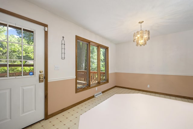 2266 E Barataria St, Springfield, MO 65804 - unfurnished dining area with light flooring, plenty of natural light, and a chandelier