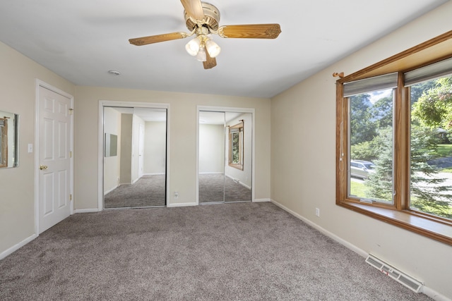 2266 E Barataria St, Springfield, MO 65804 - unfurnished bedroom with multiple closets, carpet floors, and a ceiling fan