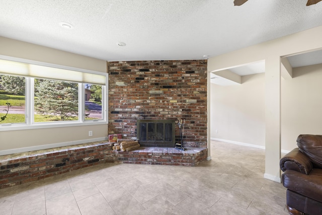 2266 E Barataria St, Springfield, MO 65804 - unfurnished living room with a textured ceiling, a brick fireplace, tile patterned flooring, and a ceiling fan
