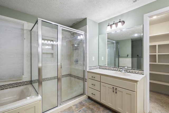 2266 E Barataria St, Springfield, MO 65804 - bathroom featuring a shower stall, vanity, a textured ceiling, and a garden tub