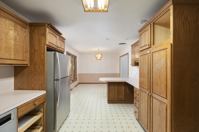 2266 E Barataria St, Springfield, MO 65804 - kitchen with stainless steel appliances, a chandelier, light flooring, light countertops, and a peninsula