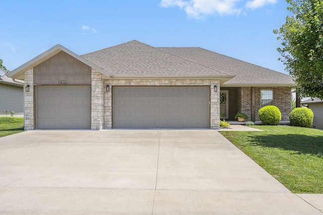 1950 S Trinidad Dr, Ozark, MO 65721 - view of front facade with an attached garage, stone siding, a shingled roof, and driveway