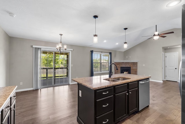 1950 S Trinidad Dr, Ozark, MO 65721 - kitchen with dishwasher, open floor plan, a tile fireplace, healthy amount of natural light, and vaulted ceiling