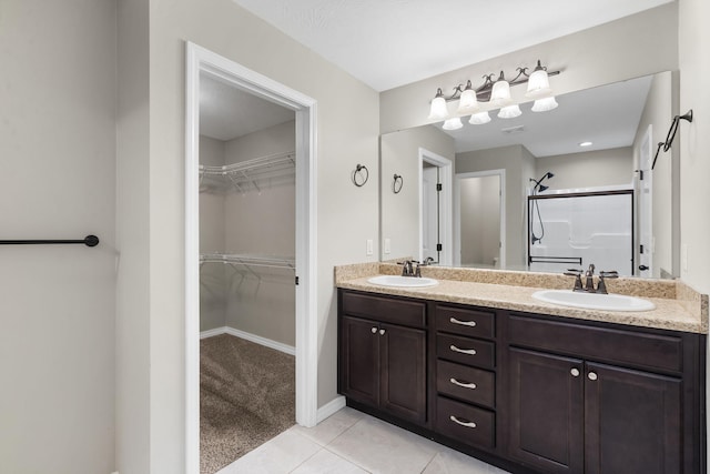 1950 S Trinidad Dr, Ozark, MO 65721 - full bathroom with a shower stall, double vanity, a spacious closet, and tile patterned floors