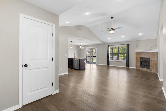 1950 S Trinidad Dr, Ozark, MO 65721 - unfurnished living room with ceiling fan, vaulted ceiling, a tile fireplace, dark wood-style flooring, and recessed lighting