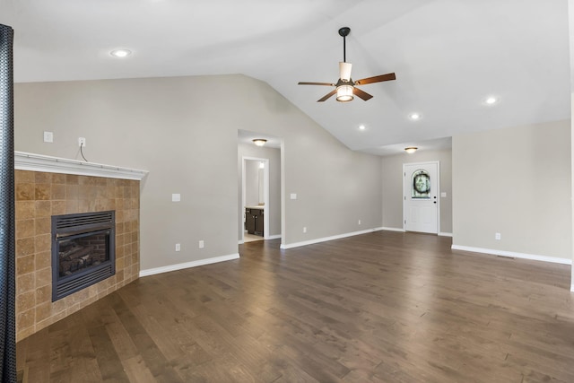 1950 S Trinidad Dr, Ozark, MO 65721 - unfurnished living room featuring a ceiling fan, a tiled fireplace, lofted ceiling, dark wood finished floors, and recessed lighting