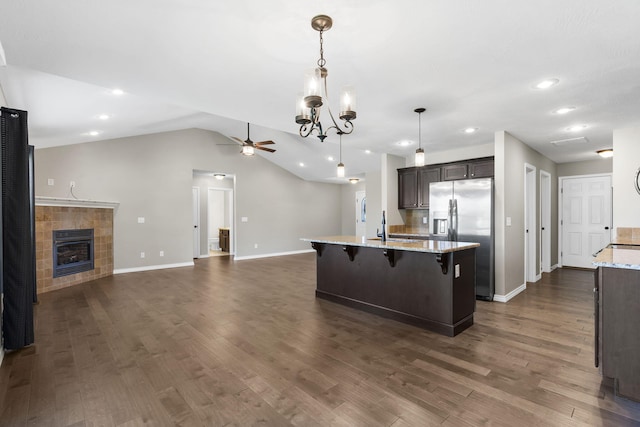 1950 S Trinidad Dr, Ozark, MO 65721 - kitchen featuring stainless steel refrigerator with ice dispenser, open floor plan, ceiling fan, dark wood-style flooring, and a kitchen island with sink
