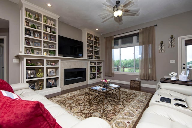 4604 E Kentbrook Dr, Springfield, MO 65802 - living area with wood finished floors, a ceiling fan, a tiled fireplace, and recessed lighting