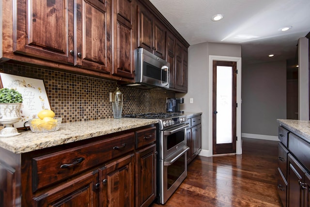 4604 E Kentbrook Dr, Springfield, MO 65802 - kitchen with appliances with stainless steel finishes, decorative backsplash, dark wood-type flooring, dark brown cabinets, and light stone counters