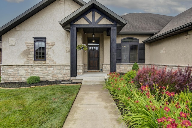 4604 E Kentbrook Dr, Springfield, MO 65802 - property entrance with stone siding, stucco siding, and a lawn