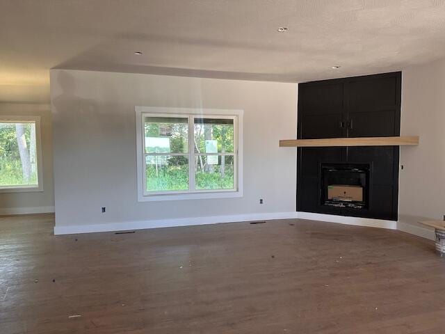 5555 E Wild Horse Dr, Springfield, MO 65802 - unfurnished living room featuring wood finished floors and a fireplace