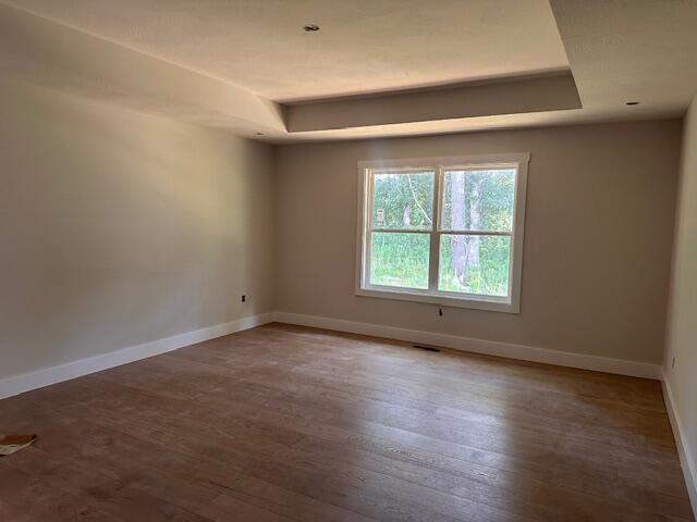 5555 E Wild Horse Dr, Springfield, MO 65802 - empty room with a raised ceiling and wood finished floors