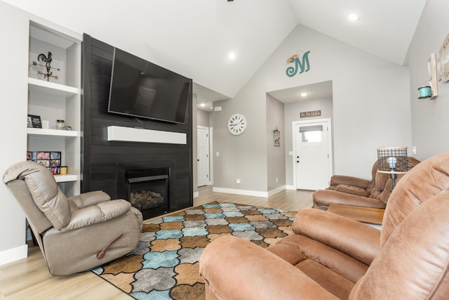 622 N Dean Ln, Republic, MO 65738 - living room featuring wood finished floors, built in features, high vaulted ceiling, a large fireplace, and recessed lighting