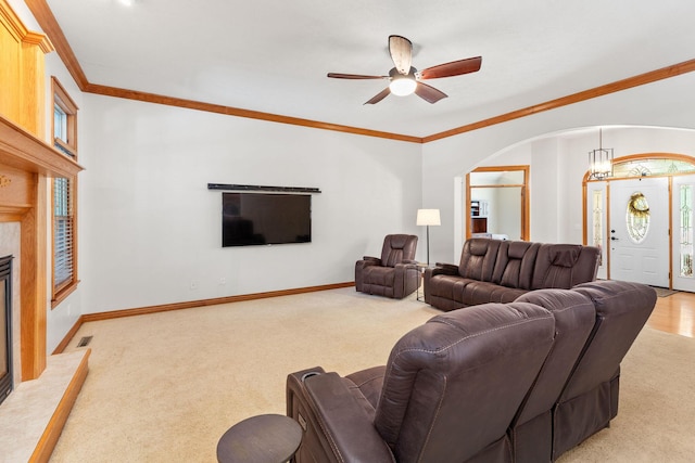 217 E Grace St, Republic, MO 65738 - living room with light colored carpet, ceiling fan, arched walkways, a premium fireplace, and crown molding