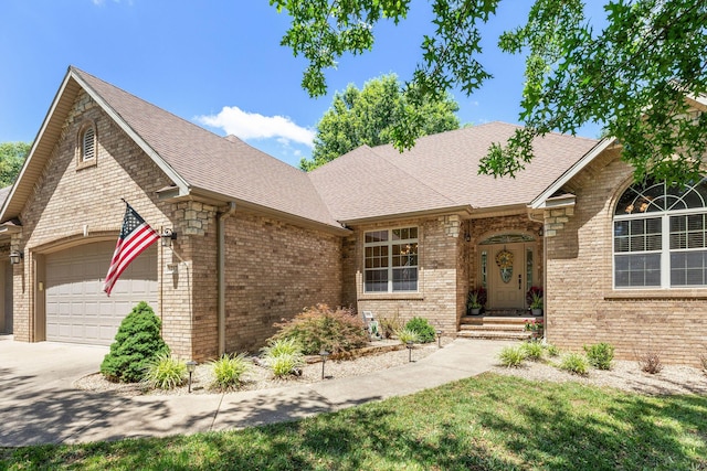 217 E Grace St, Republic, MO 65738 - view of front of home featuring brick siding, an attached garage, a shingled roof, and driveway