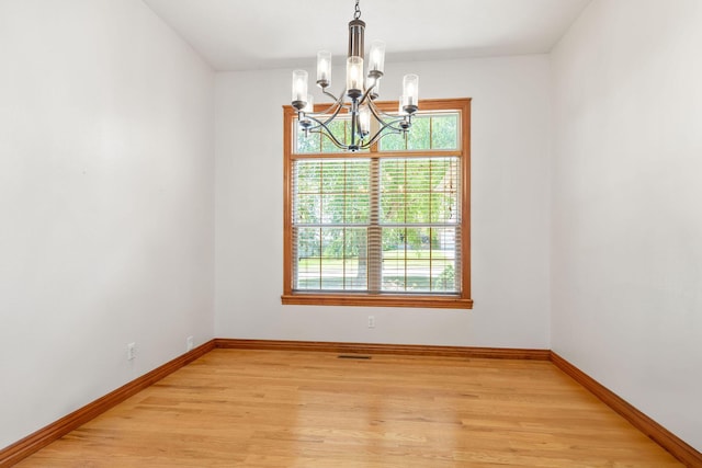 217 E Grace St, Republic, MO 65738 - empty room featuring a chandelier, plenty of natural light, and light wood-type flooring