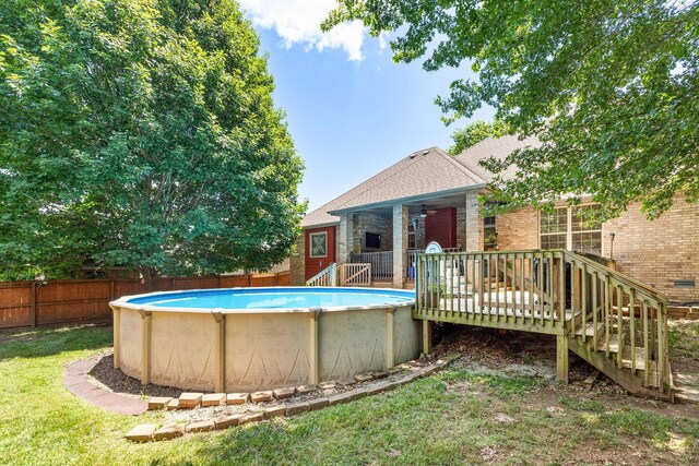 217 E Grace St, Republic, MO 65738 - view of pool featuring a wooden deck, a fenced backyard, and a ceiling fan