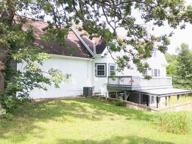 6540 Gateway Dr, Joplin, MO 64804 - back of house with stucco siding, a yard, a wooden deck, and roof with shingles