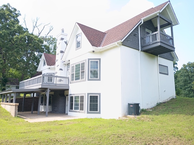 6540 Gateway Dr, Joplin, MO 64804 - back of house with a balcony, a lawn, a chimney, and a patio