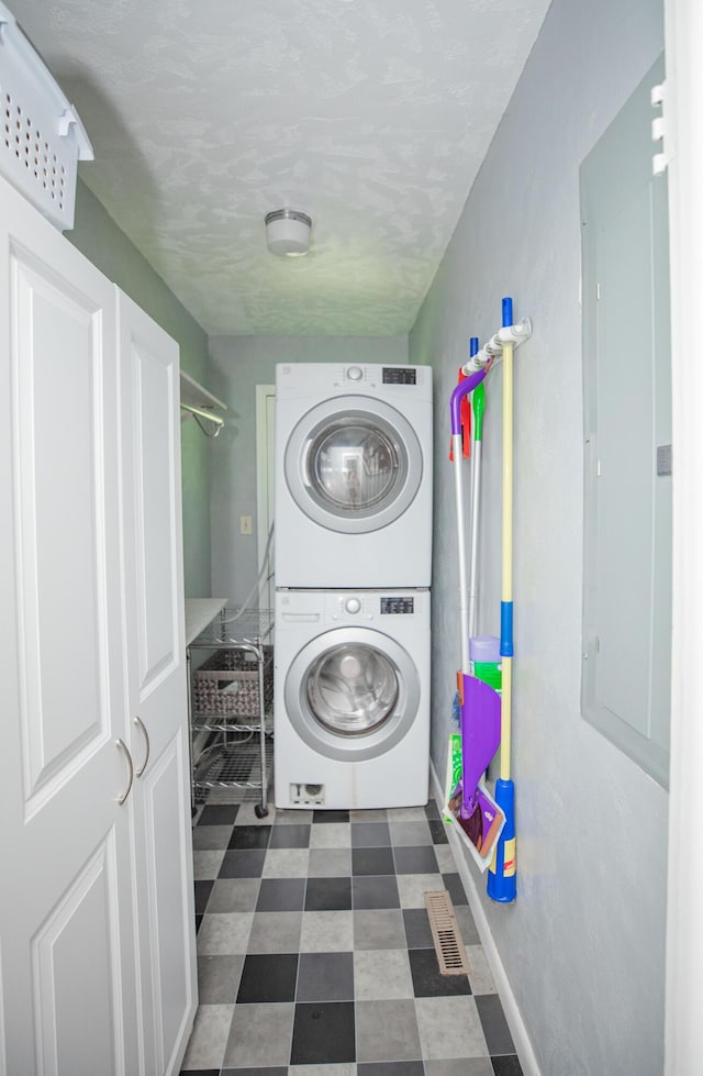 619 Rte H, Greenfield, MO 65661 - laundry area with stacked washing machine and dryer and dark floors