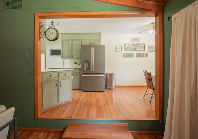 619 Rte H, Greenfield, MO 65661 - kitchen with stainless steel fridge with ice dispenser, a ceiling fan, light wood-style flooring, light countertops, and beam ceiling