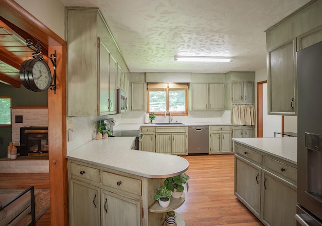 619 Rte H, Greenfield, MO 65661 - kitchen featuring appliances with stainless steel finishes, light countertops, plenty of natural light, light wood-style flooring, and a textured ceiling