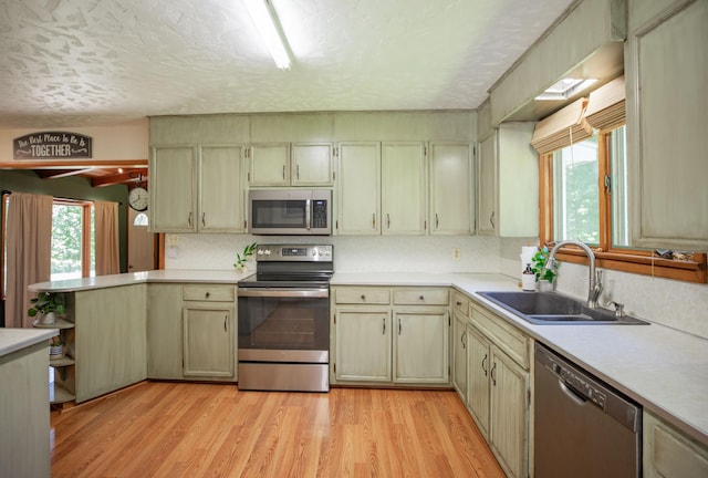 619 Rte H, Greenfield, MO 65661 - kitchen featuring appliances with stainless steel finishes, light countertops, light wood-style floors, a textured ceiling, and a peninsula
