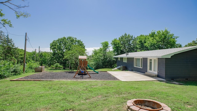 619 Rte H, Greenfield, MO 65661 - view of grassy yard with an outdoor fire pit, a patio area, and a playground