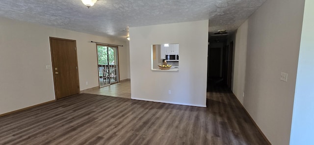 2830 N Washington Ave, Springfield, MO 65803 - empty room with wood finished floors and a textured ceiling