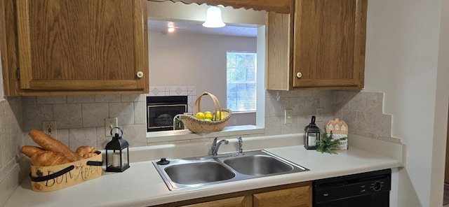 2830 N Washington Ave, Springfield, MO 65803 - kitchen with dishwasher, brown cabinetry, light countertops, and decorative backsplash