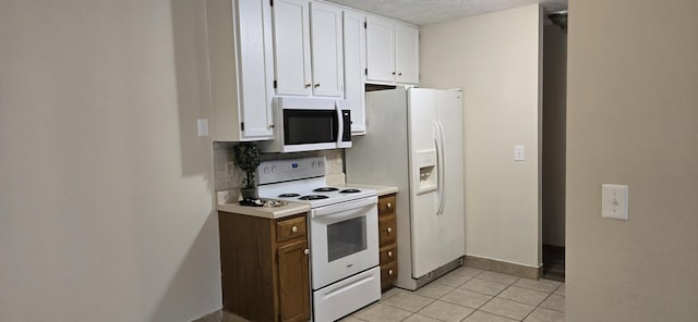 2830 N Washington Ave, Springfield, MO 65803 - kitchen with white appliances, white cabinetry, light tile patterned floors, and light countertops