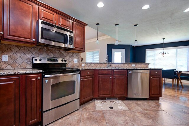 645 Galileo Dr, Nixa, MO 65714 - kitchen featuring stainless steel appliances, ornamental molding, decorative backsplash, plenty of natural light, and recessed lighting