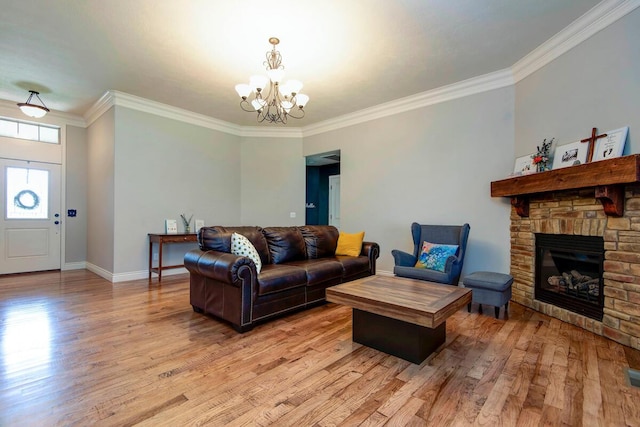 645 Galileo Dr, Nixa, MO 65714 - living area with a chandelier, crown molding, light wood-style floors, and a stone fireplace
