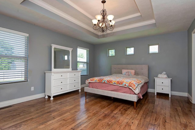 645 Galileo Dr, Nixa, MO 65714 - bedroom featuring a raised ceiling, a chandelier, wood-type flooring, and ornamental molding