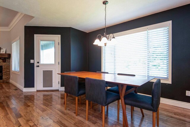 645 Galileo Dr, Nixa, MO 65714 - dining room featuring a chandelier, wood finished floors, and crown molding