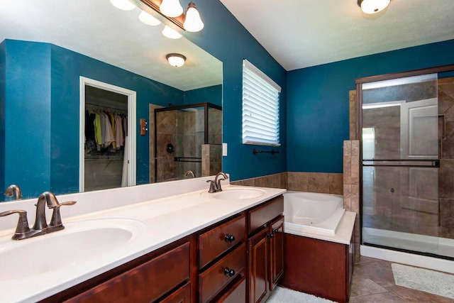 645 Galileo Dr, Nixa, MO 65714 - bathroom with a stall shower, a garden tub, a walk in closet, double vanity, and tile patterned floors