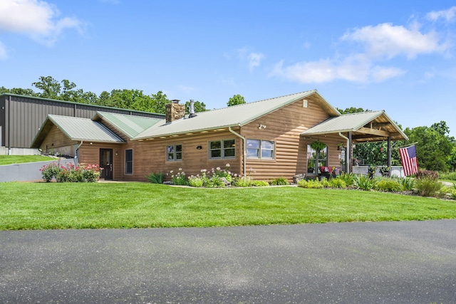 14410 Native Dr, Phillipsburg, MO 65722 - view of front of house with a chimney, a front lawn, and a metal roof