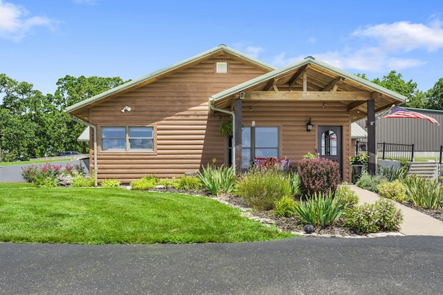 14410 Native Dr, Phillipsburg, MO 65722 - rustic home featuring a front lawn and faux log siding