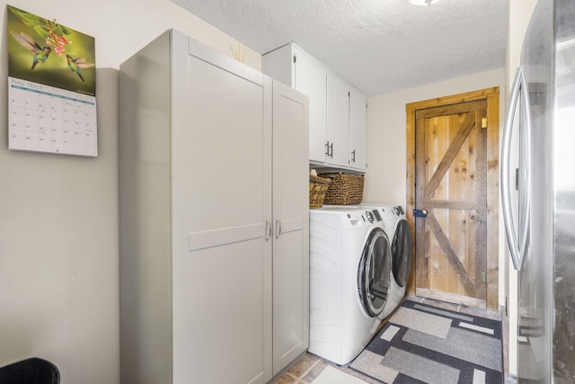 14410 Native Dr, Phillipsburg, MO 65722 - washroom with cabinet space, independent washer and dryer, and a textured ceiling